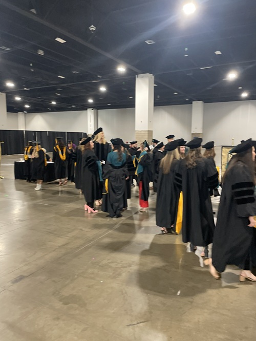 Students gathered in the Convention Center in caps and gowns.