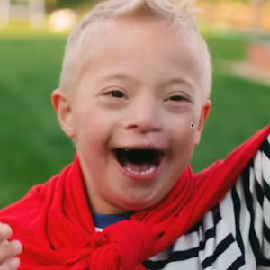 Young boy with Down syndrome smiling