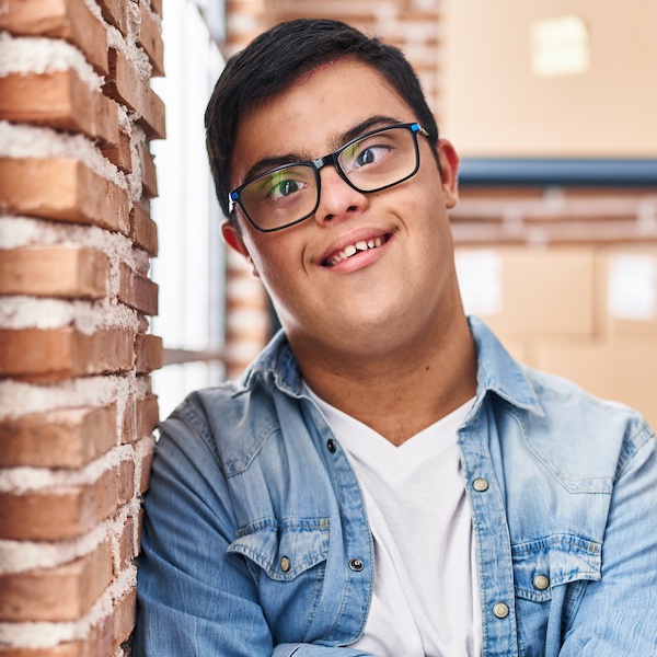 Image of young man with Down syndrome wearing glasses