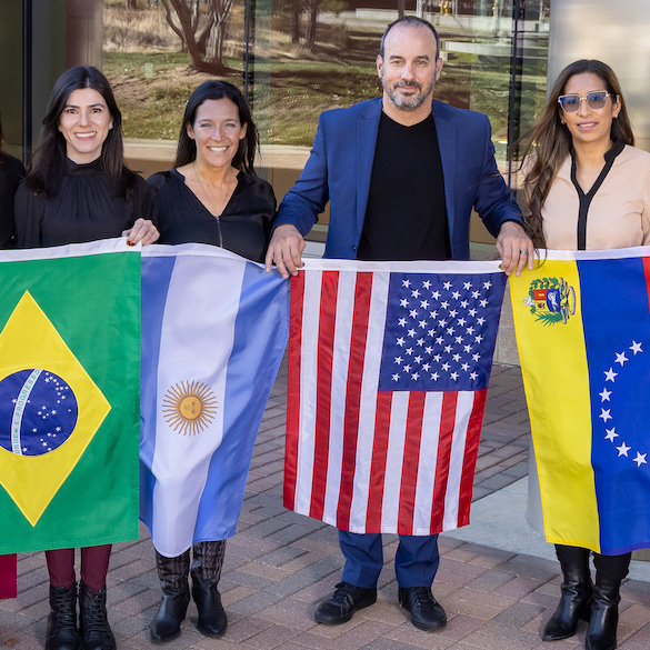 Dr. Joaquin Espinosa and the HTP - Latin America Network posing with flags from their home countries