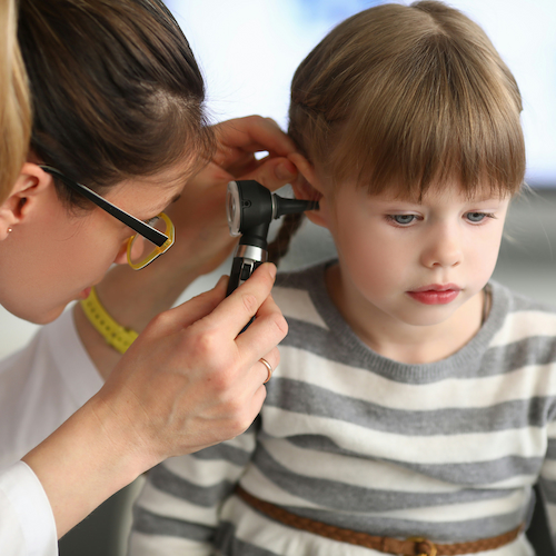 Doctor looking in childs ear