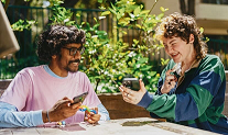 two people sharing phone photos
